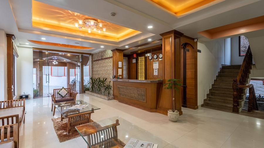 Lobby area with seating arrangements and a staircase leading upwards at DLS Hotels The Rock Castle.
